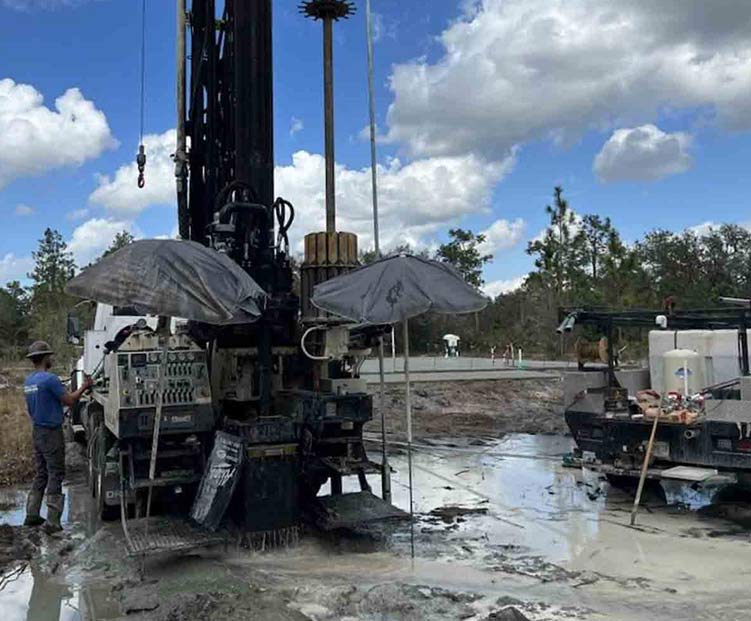 Crew-working-on-well-drilling-square Dick Joyce teammate working on drilling a water well